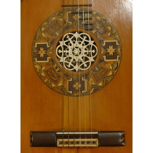 1092 - A classical acoustic Spanish guitar with parquetry decoration and pierced ivory centre in fitted cas... 