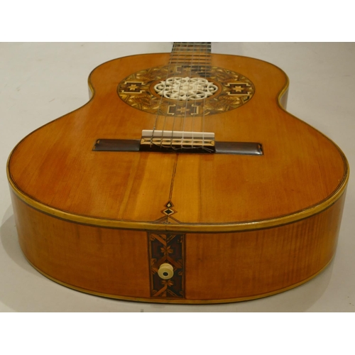 1092 - A classical acoustic Spanish guitar with parquetry decoration and pierced ivory centre in fitted cas... 