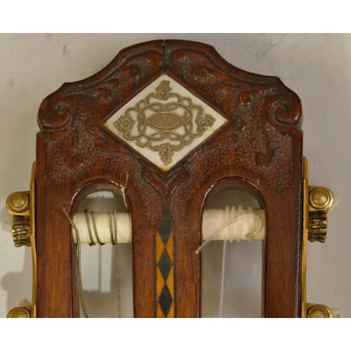 1092 - A classical acoustic Spanish guitar with parquetry decoration and pierced ivory centre in fitted cas... 