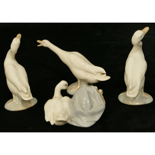 110 - A Lladro group of bird with chicks in a basket, 9.5cm wide and 3 Lladro figures of geese. (4)