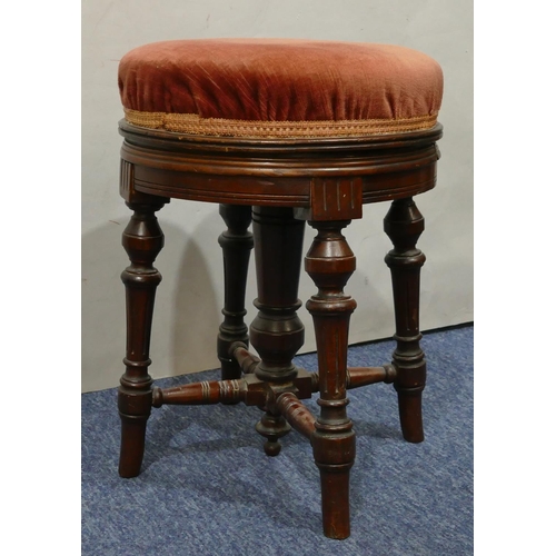 1150 - A 19th Century mahogany swivel topped round piano stool with overstuffed pink velvet top on 4 turned... 