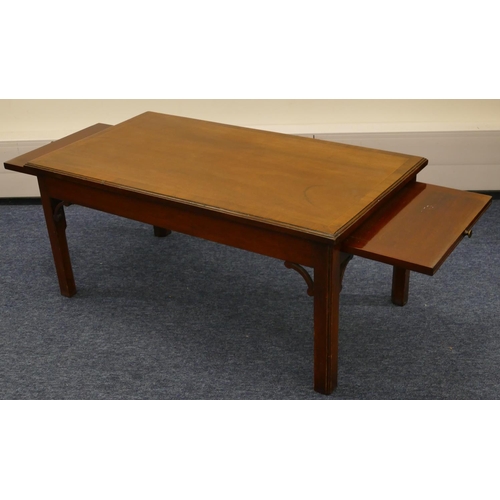 1154 - A mahogany rectangular shaped coffee table with banded top, brush slides to each end on square chamf... 