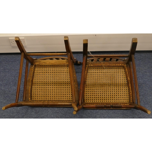 1162 - A pair of walnut single chairs with spindle backs and cane seats on splayed legs (2)