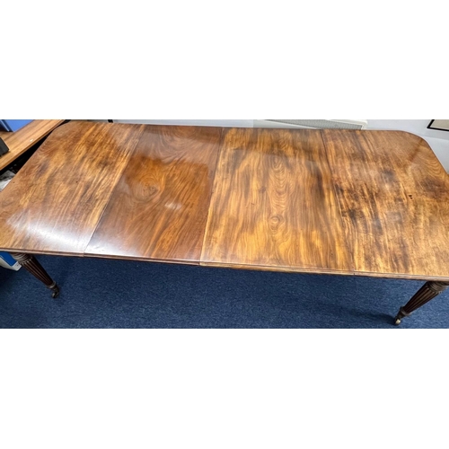 1169 - A Georgian mahogany draw leaf dining table having 2 extra leaves on round turned fluted legs 270 x 1... 