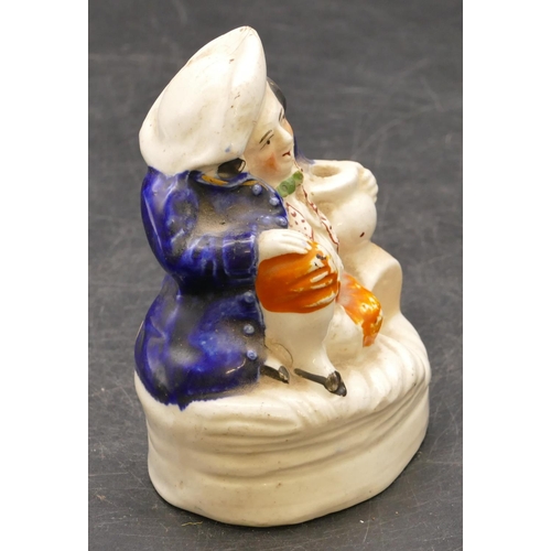 13 - A 19th Century small Staffordshire pen stand in the form of a seated figure holding a jug, 11.5cm hi... 