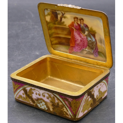 148 - A porcelain rectangular shaped snuff box with gilt metal hinged lid, top depicting 2 figures and cup... 