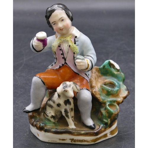 165 - A 19th Century china pen holder in the form of a seated gentleman with a dog at his feet, 11.5cm hig... 