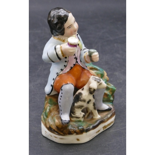 165 - A 19th Century china pen holder in the form of a seated gentleman with a dog at his feet, 11.5cm hig... 