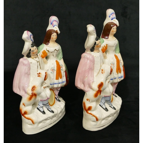 182 - 2 19th Century Staffordshire groups of seated gentleman and standing lady with dog and musical instr... 