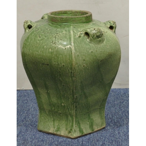 189 - A Chinese green glazed hexagonal bulbous shaped vase with raised animal head motifs, 30.5cm high.