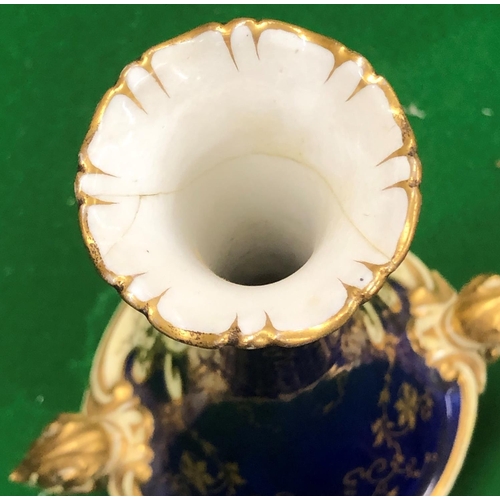 191 - A Coalport round bulbous thin necked trumpet shaped 2 handled vase on blue and cream ground with han... 