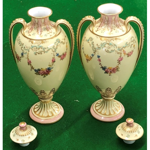 194 - A Pair Royal Crown Derby round bulbous thin necked 2 handled lidded vases on cream ground with flora... 