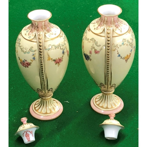 194 - A Pair Royal Crown Derby round bulbous thin necked 2 handled lidded vases on cream ground with flora... 