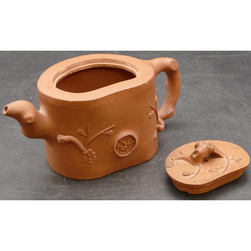 21 - A Chinese earthenware teapot with raised branch and leaf decoration, 10cm high