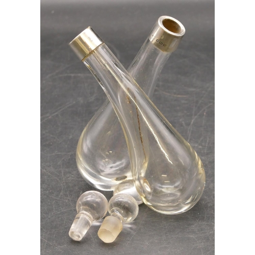 251 - A plain glass double-ended vinegar bottle with stoppers and Birmingham silver necks, 13.5cm high