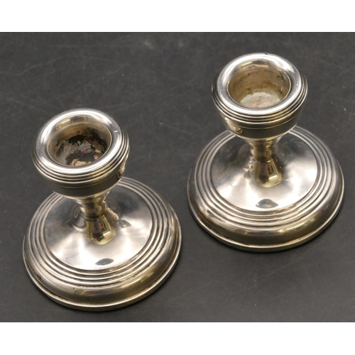 252 - A pair of modern Birmingham silver dwarf candlesticks on round sweeping bases, 7cm high