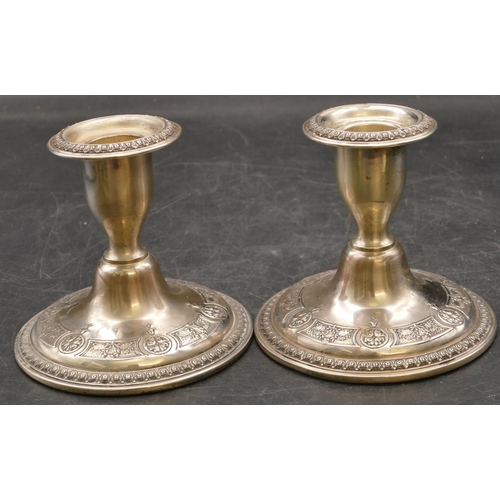 259 - A pair of American sterling silver round bulbous shaped dwarf candlesticks with embossed floral and ... 