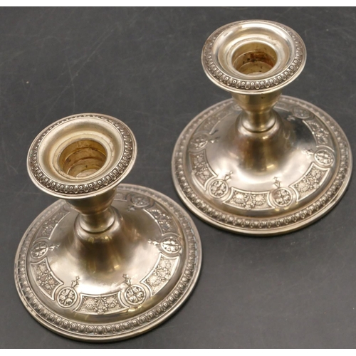 259 - A pair of American sterling silver round bulbous shaped dwarf candlesticks with embossed floral and ... 