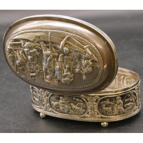 264 - A Continental oval silver coloured metal trinket box with hinged lid, allover embossed figures in bo... 