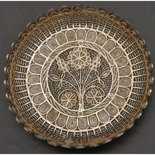 268 - An Eastern silver coloured metal filigree round shallow dish with pierced floral decoration and scal... 