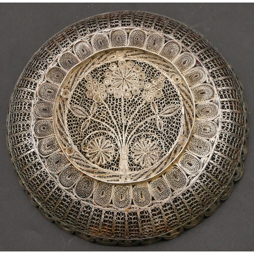 268 - An Eastern silver coloured metal filigree round shallow dish with pierced floral decoration and scal... 