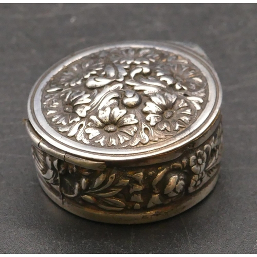 277 - A modern 925 silver round pill box with hinged lid and embossed floral and scroll decoration, 3.5cm ... 