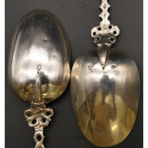 278 - A pair of 18th/19th Century Dutch silver coloured metal marriage spoons with figure motifs, pierced ... 