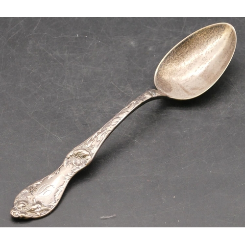 281 - A sterling silver spoon with raised leaf and scroll handle, 2.3oz