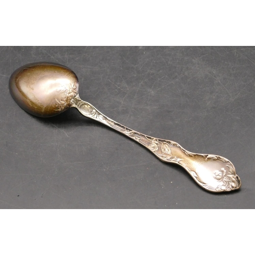 281 - A sterling silver spoon with raised leaf and scroll handle, 2.3oz