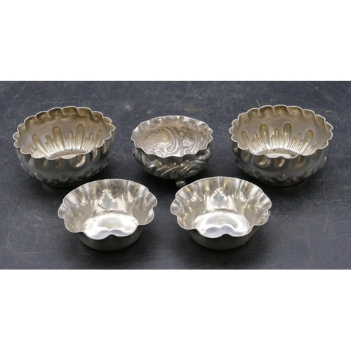 335 - A pair of Sheffield silver round scallop shaped salts with part embossed decoration and crinkled rim... 