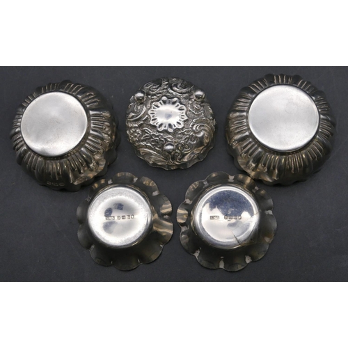 335 - A pair of Sheffield silver round scallop shaped salts with part embossed decoration and crinkled rim... 