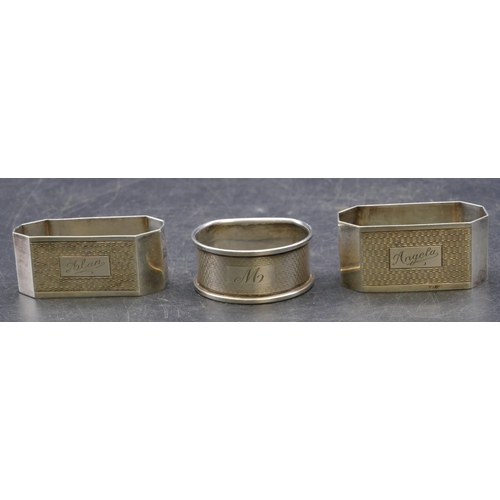 336 - A pair of Birmingham silver rectangular shaped napkin rings with chamfer corners, engraved inscripti... 