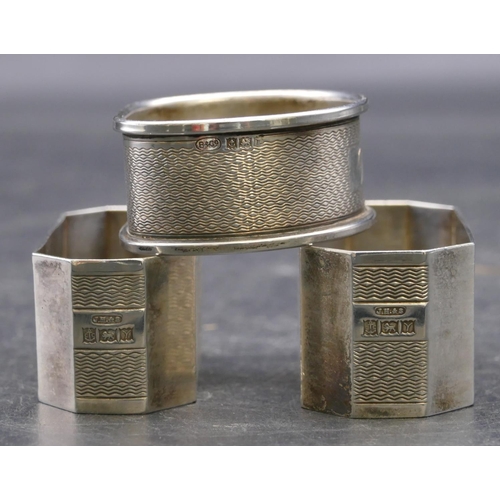 336 - A pair of Birmingham silver rectangular shaped napkin rings with chamfer corners, engraved inscripti... 