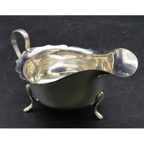 338 - A Birmingham silver sauce boat with crinkled rim on 3 splayed feet, 3oz.