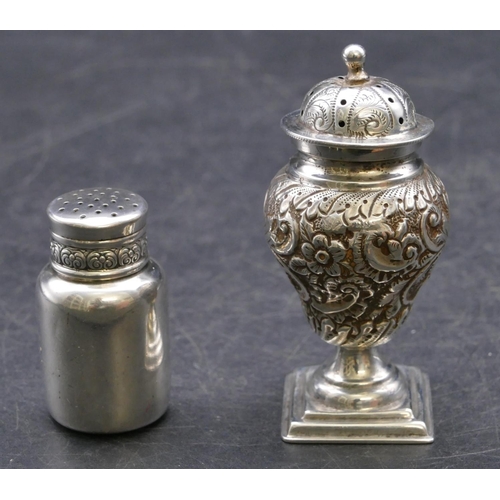 354 - A Sheffield silver round bulbous shaped pepper with embossed floral, leaf and scroll decoration, on ... 