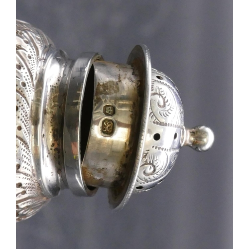 354 - A Sheffield silver round bulbous shaped pepper with embossed floral, leaf and scroll decoration, on ... 