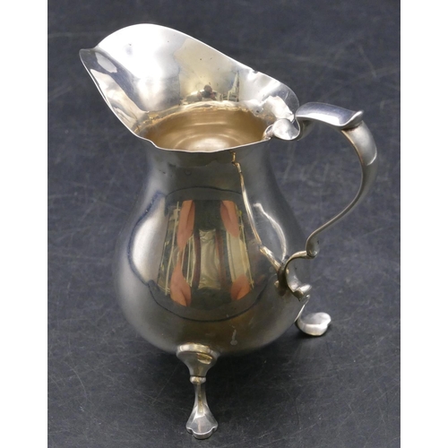 358 - A Sheffield silver round bulbous shaped cream jug inscribed 