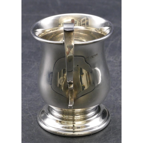 360 - A modern London silver round bulbous shaped christening mug with scroll handle on sweeping foot, 3.2... 