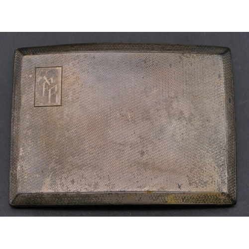 364 - A Sheffield silver concave shaped cigarette case with engine turn decoration, hinged front, 4.8oz.