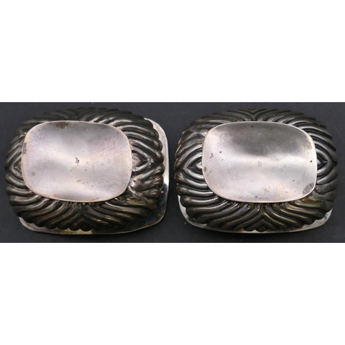 372 - A pair of Chester silver rectangular bulbous shaped salts with blue glass liners, half embossed reed... 