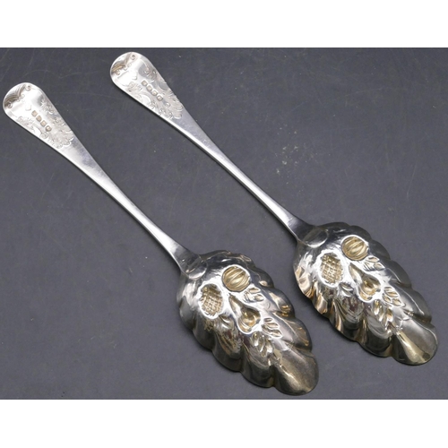 395 - A pair of George III silver berry spoons with embossed crinkled bowls and raised fruit decoration, e... 