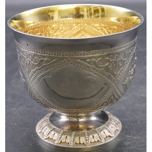 406 - A Victorian silver round bowl with gilt inner rim with allover embossed and engraved floral, leaf an... 