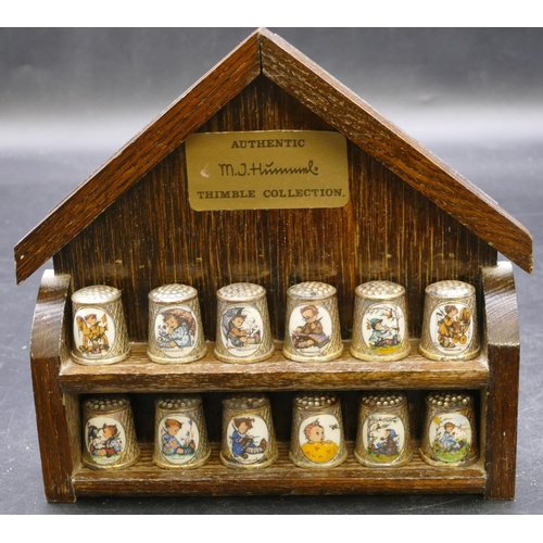 410 - A set of 12 German silver plated thimbles with enamelled Hummel decoration.