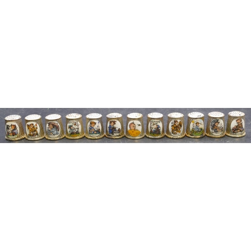 410 - A set of 12 German silver plated thimbles with enamelled Hummel decoration.