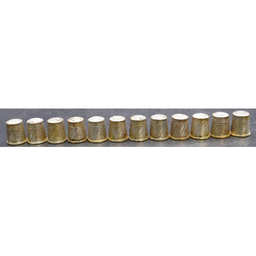 410 - A set of 12 German silver plated thimbles with enamelled Hummel decoration.