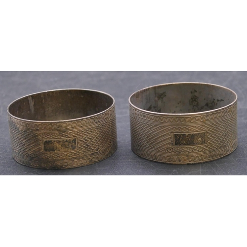 411 - A pair of Birmingham silver round napkin rings with engine turned decoration, 1oz