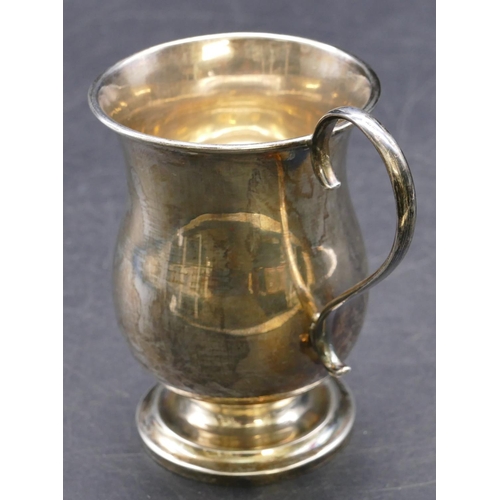 415 - A Sheffield silver round bulbous shaped christening mug with scroll handle, sweeping foot with engra... 