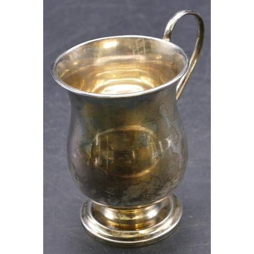 415 - A Sheffield silver round bulbous shaped christening mug with scroll handle, sweeping foot with engra... 