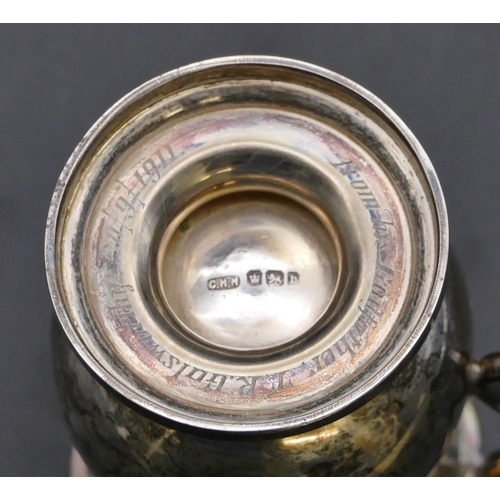 415 - A Sheffield silver round bulbous shaped christening mug with scroll handle, sweeping foot with engra... 