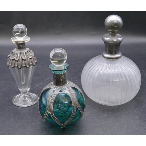 437 - A clear glass round bulbous thin necked scent bottle with stopper and silver neck, 15cm high, a gree... 